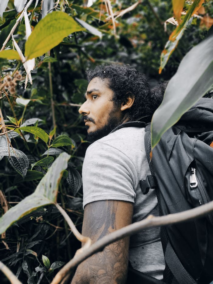 A man hiking through the dense jungle of Wewalwatta, Sri Lanka.